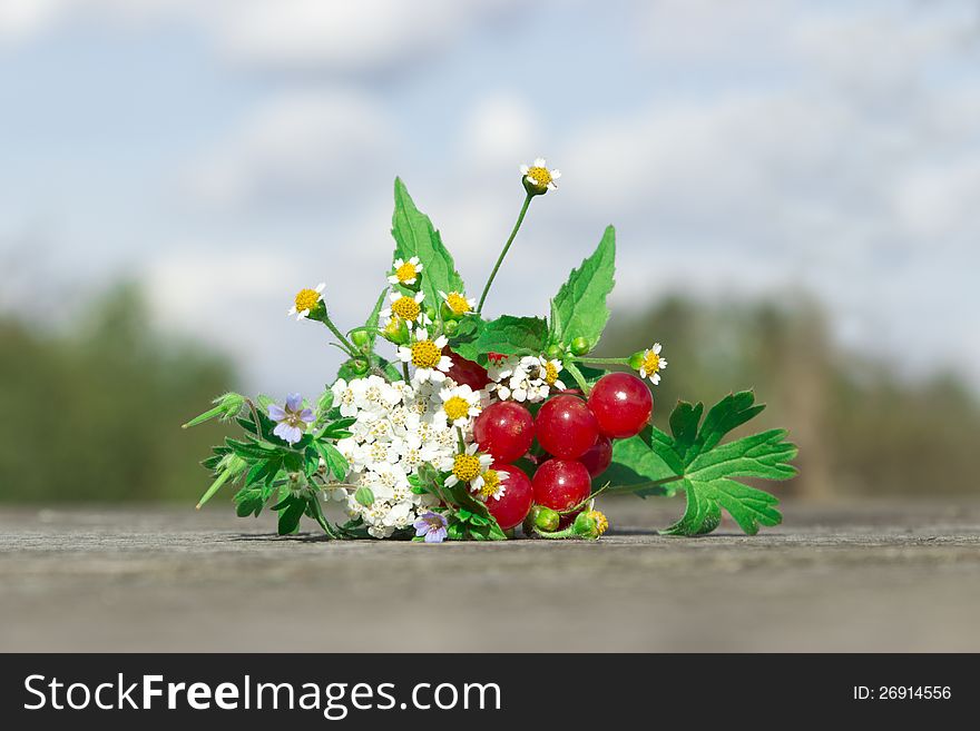 Bouquet of flowers and berries on the table