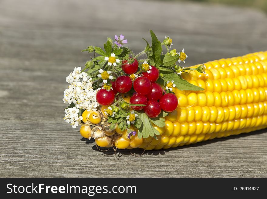 Thr bouquet of flowers and berries with corn