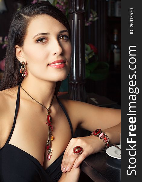 Elegant young woman with jewelry in bar. Elegant young woman with jewelry in bar
