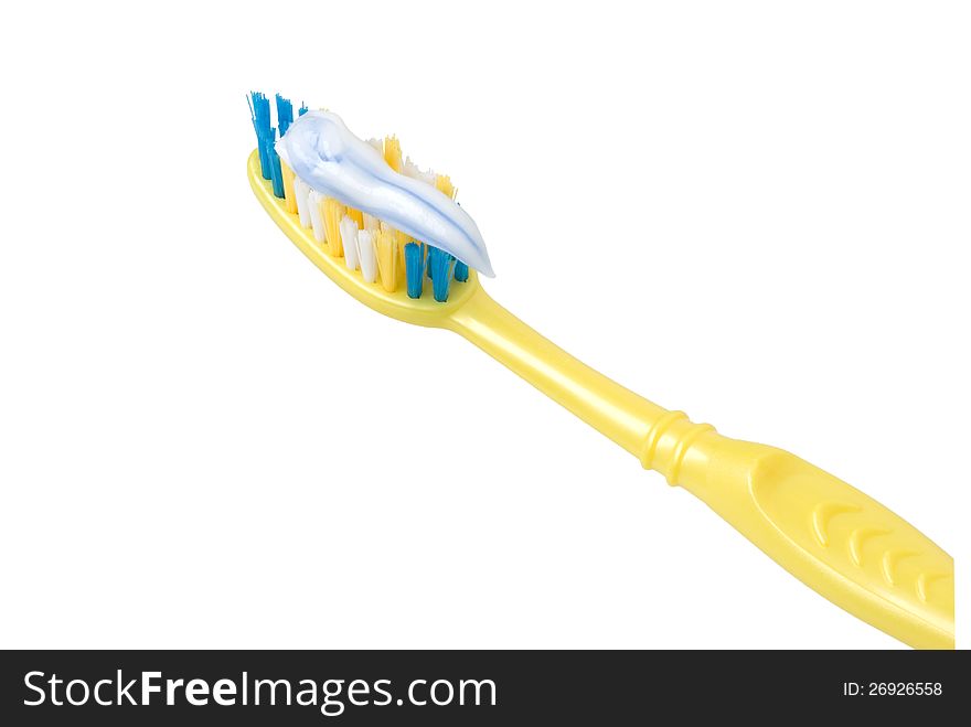 Yellow toothbrush coated with a toothpaste