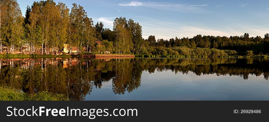Panorama of the coast of the lake in quiet summer evening. Panorama of the coast of the lake in quiet summer evening