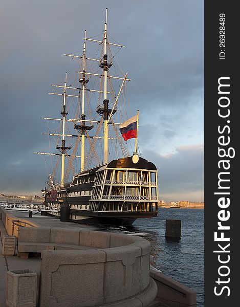 Ancient sailing vessel at granite pier on the Neva River in the city of St. Petersburg