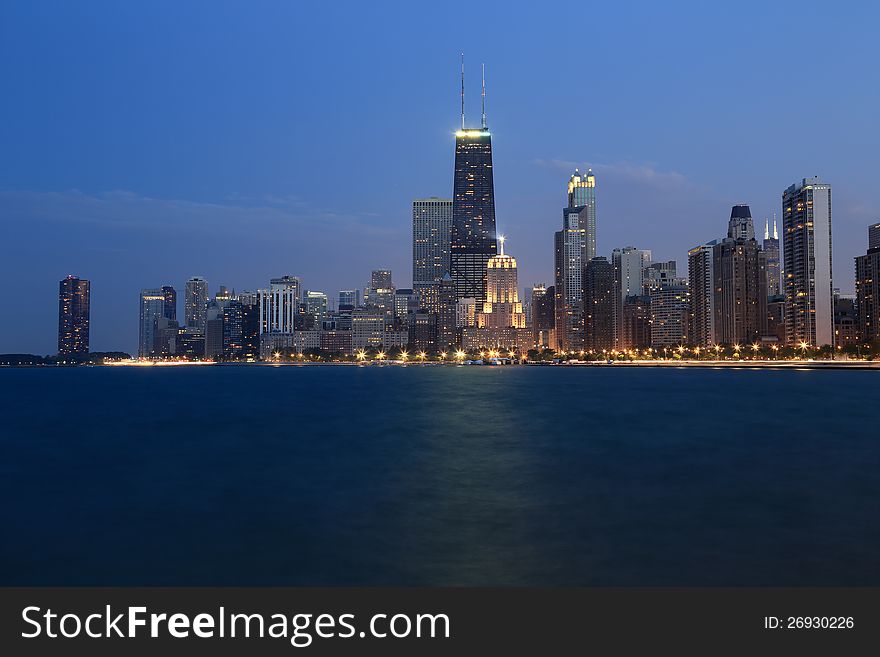 Horizontal view of the Chicago skyline at dusk from pier along Lake Michigan. Horizontal view of the Chicago skyline at dusk from pier along Lake Michigan