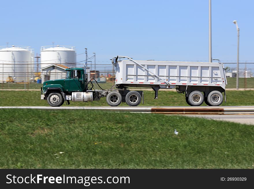 Old green dump truck on the road