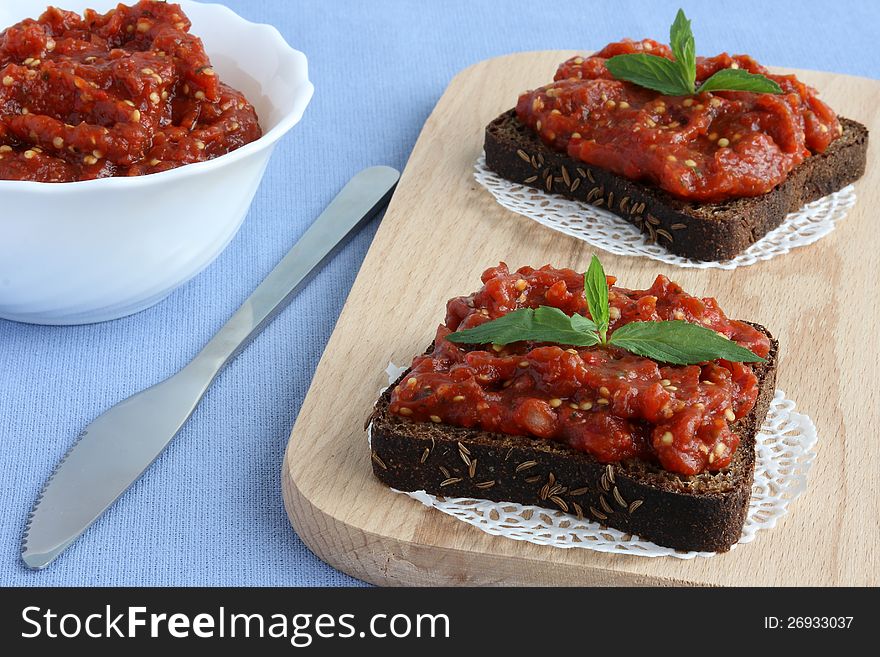 Black bread and vegetable paste on the board