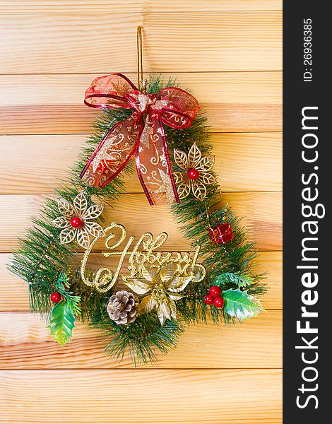 Christmas Wreath Hanging On A Wooden Wall