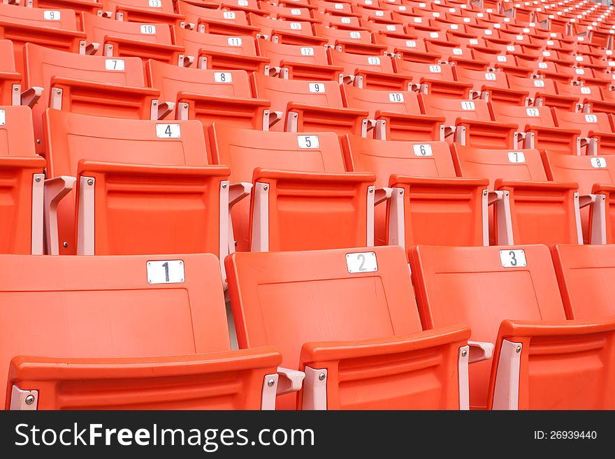 Empty bright red stadium seats. Empty bright red stadium seats