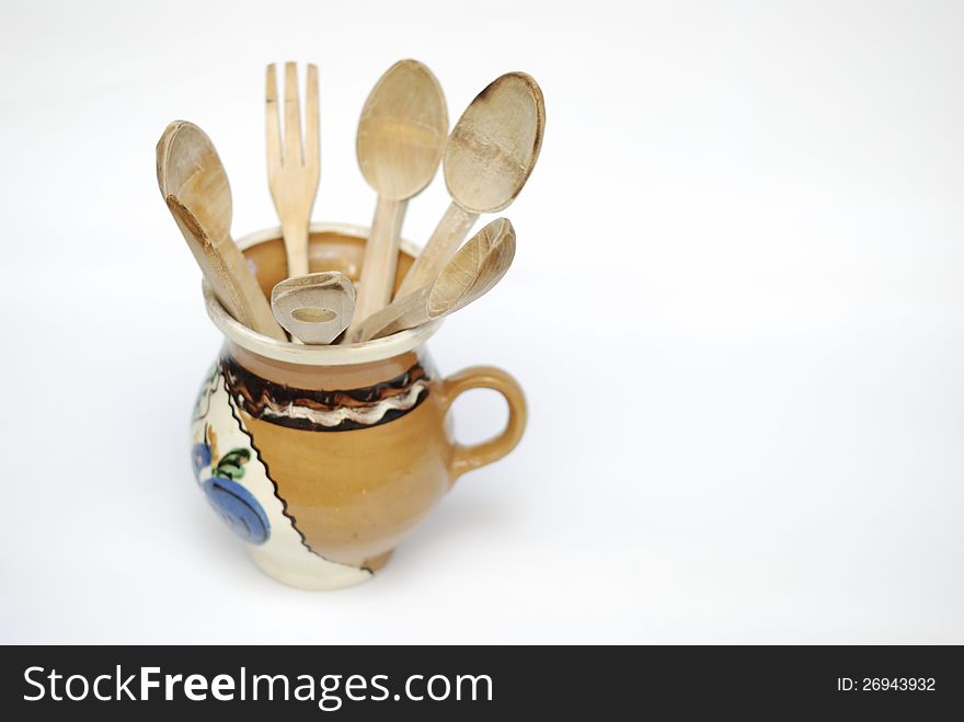 Wooden utensils on pottery vase. Wooden utensils on pottery vase