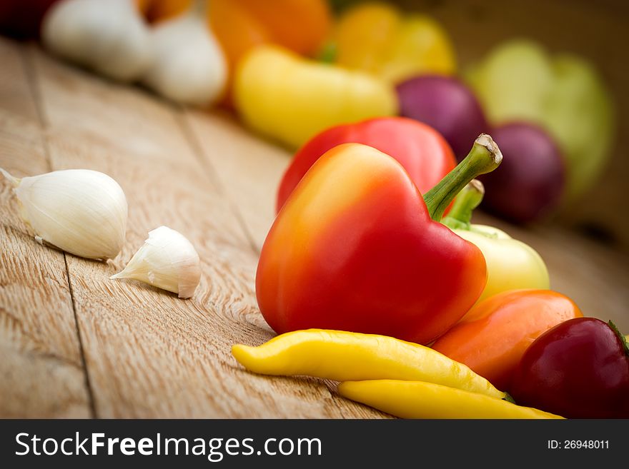 Multicolored peppers - colorful peppers on the table. Multicolored peppers - colorful peppers on the table