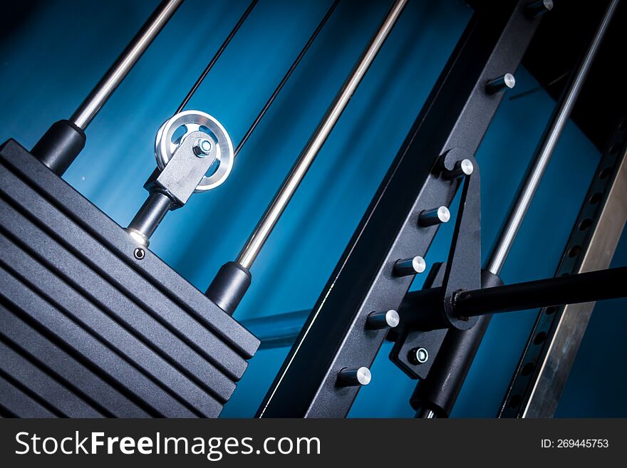 Private gym machine station at home closeup on pulley and weight