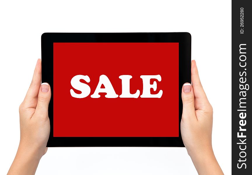 Female hands holding a tablet touch computer pad gadget with the word sale on a red screen