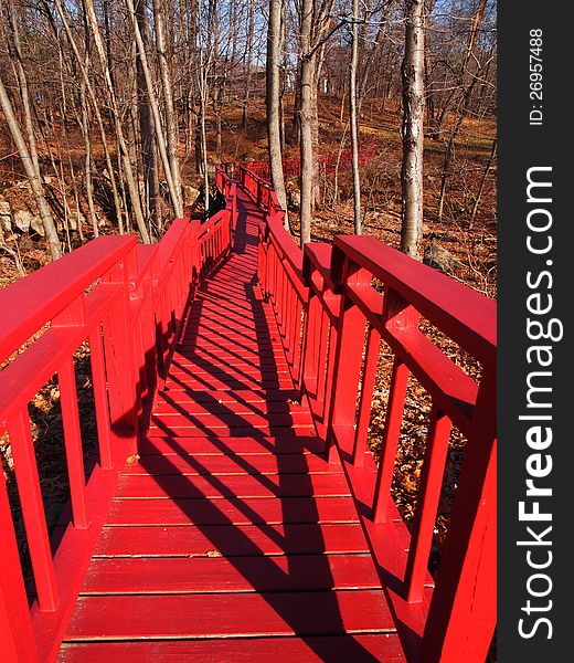 Picture of the red bridge in the forest in fall time (sunny day). Picture of the red bridge in the forest in fall time (sunny day)