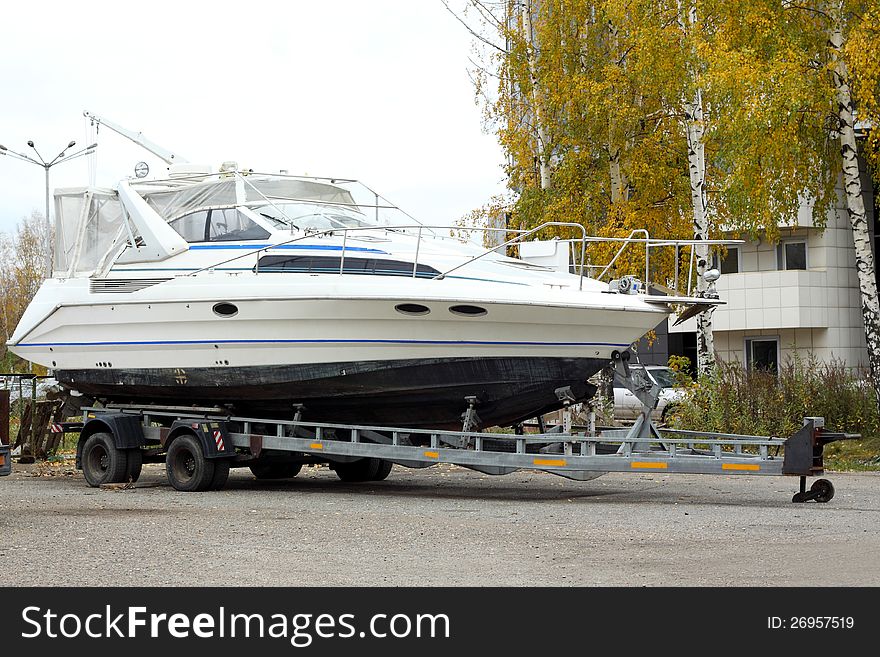 The big motor yacht is loaded on a trailer