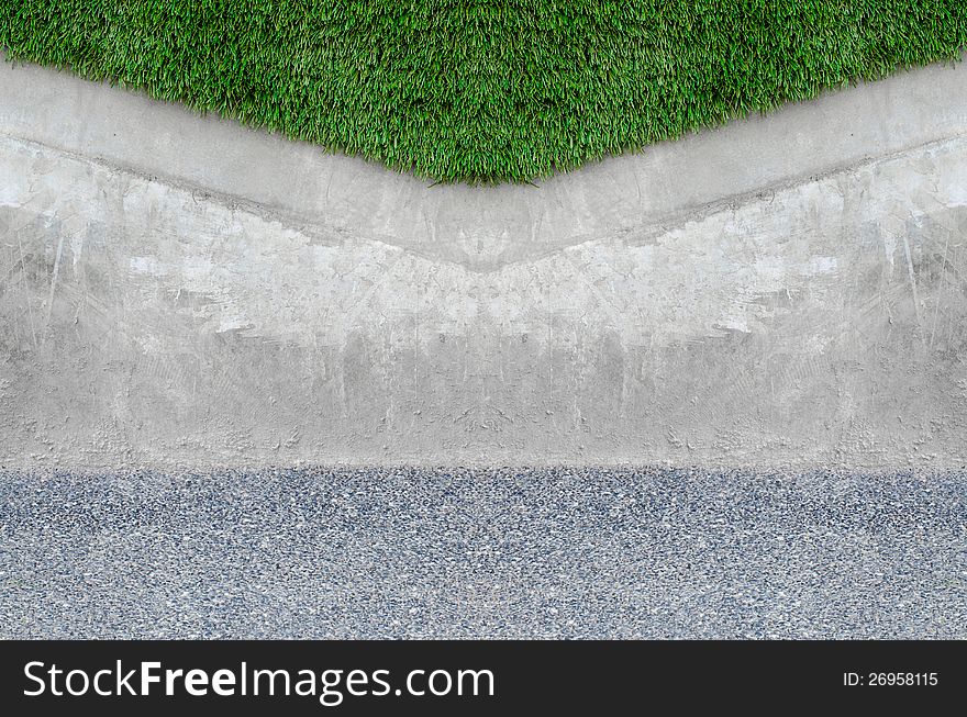 Artificial grass on a cement wall background