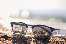 Sunglasses On A Sandy Beach. Sunset By The Sea. Background In Bokeh. Vacation At The Sea. Flight To The Journey. Royalty Free Stock Photos