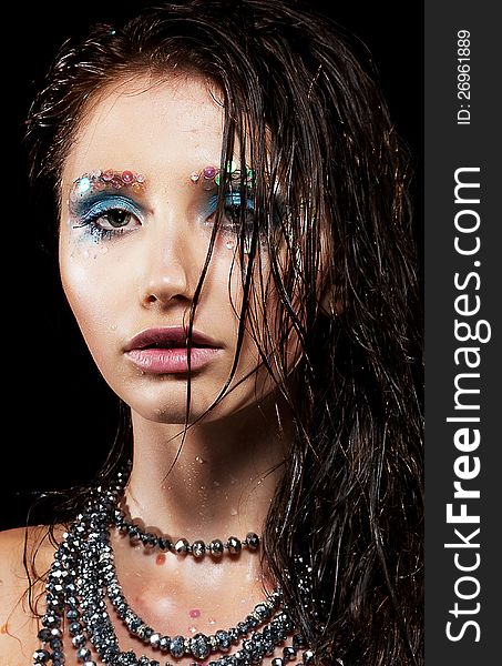 Portrait of young woman with beautiful face and wet hairs closeup