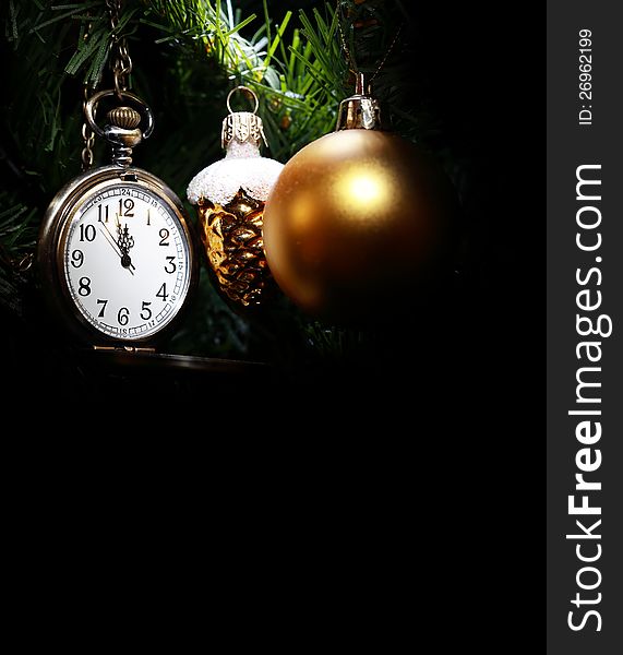 Vintage pocket watch hanging on Christmas tree near decorations. Vintage pocket watch hanging on Christmas tree near decorations