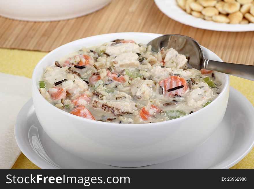 Bowl of chicken and rice soup with carrots and celery. Bowl of chicken and rice soup with carrots and celery