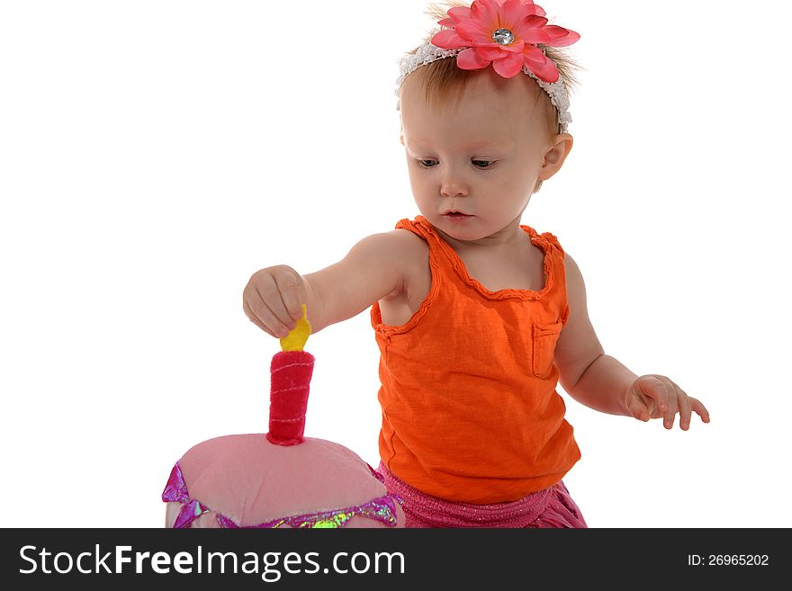 Little Girl with flower on her head and playing with a toy candle