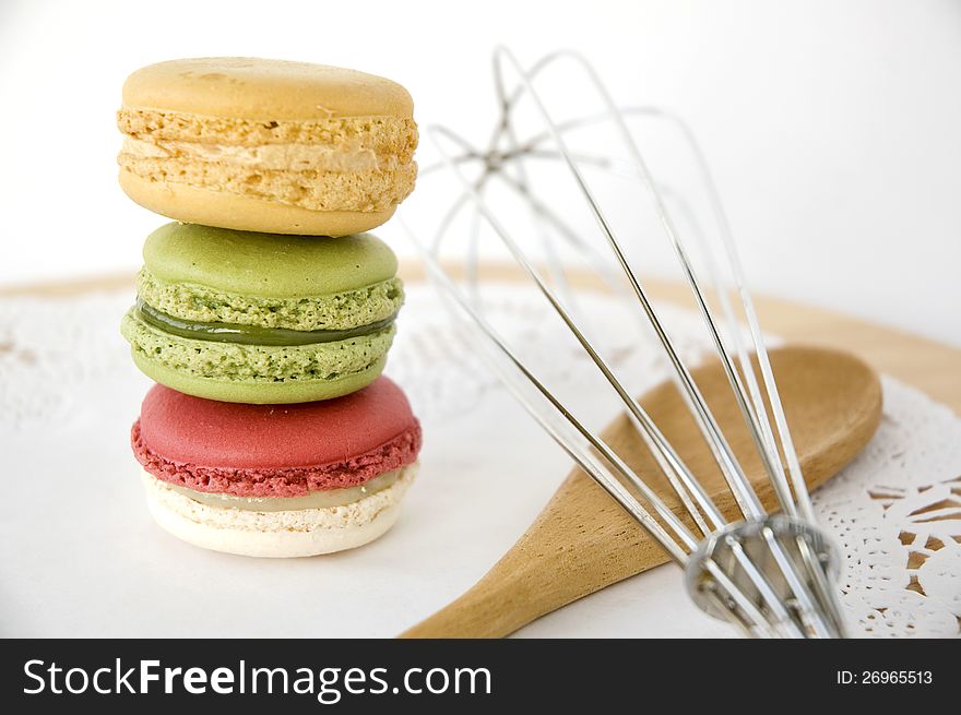 Stack of colorful macarons with kitchenware. Stack of colorful macarons with kitchenware