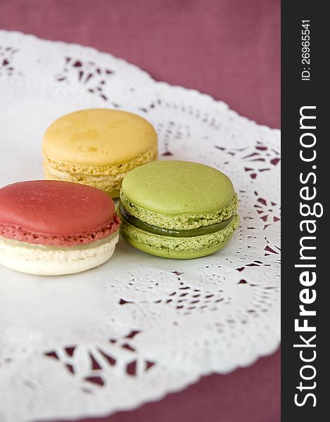 Three of french macarons on color background. Three of french macarons on color background