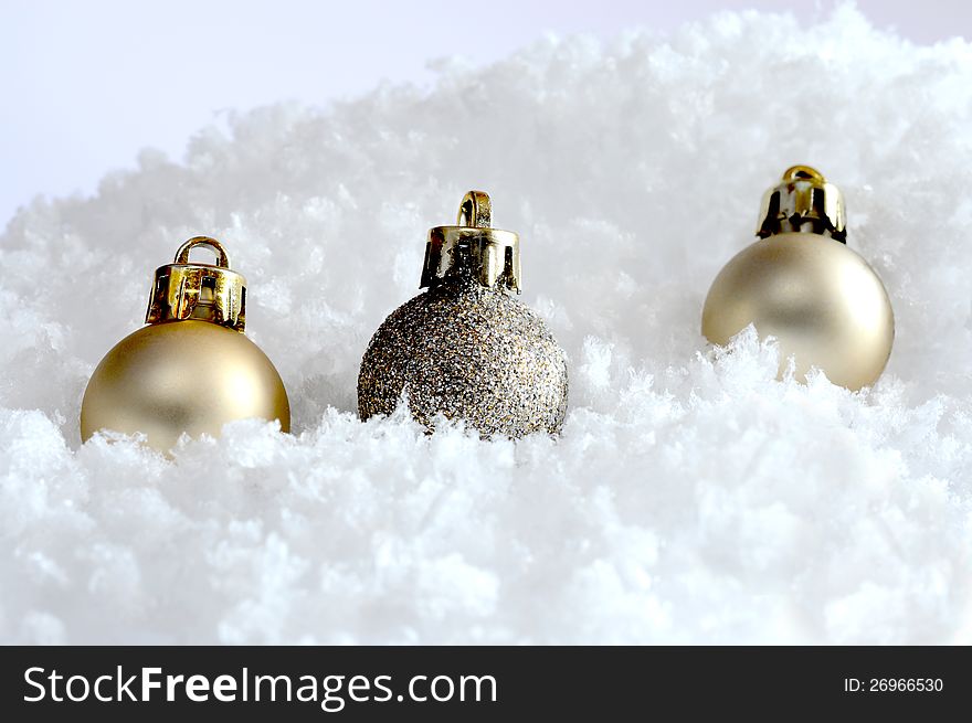 Studio image of three seasonal decorations in snow. Copy space. Studio image of three seasonal decorations in snow. Copy space.