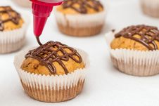 Muffins Get A Chocolate Glaze Royalty Free Stock Photography