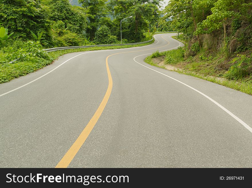 Curve road beside mountain in Thailand. Curve road beside mountain in Thailand.