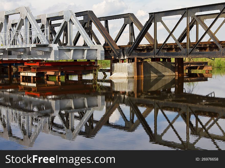 Both the new and old steel railroad bridge used to have long been a reflection of the flood water. Both the new and old steel railroad bridge used to have long been a reflection of the flood water.