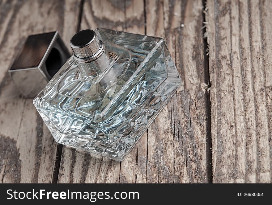 Parfume bottle on old wooden table