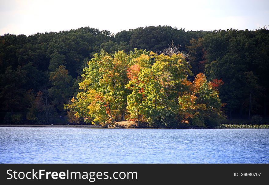 Sun rays falling on the small island in the lake