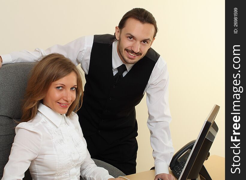 Businessman and businesswoman smiling with computer. Businessman and businesswoman smiling with computer