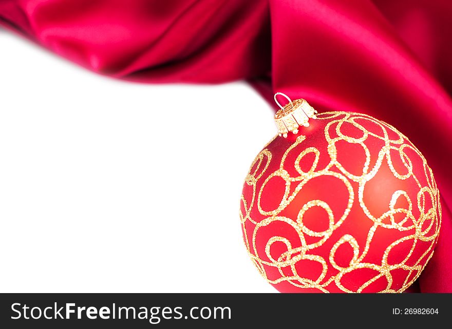 Christmas bauble and  the red silk  background. Christmas bauble and  the red silk  background