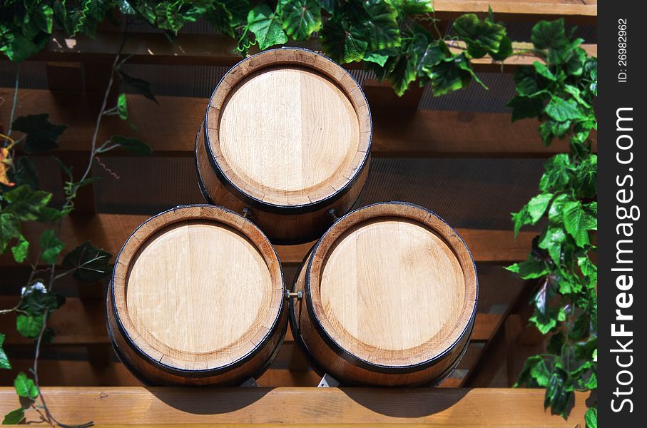 Three new barrels for wine in the leaves of grapes
