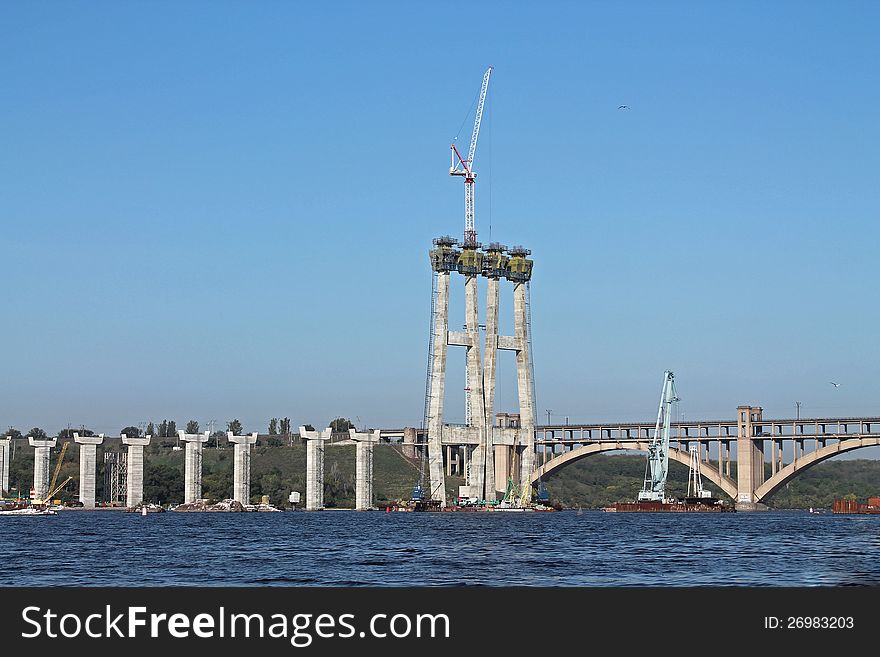Construction of a new bridge across the Dnieper River in Zaporizhzhia, Ukraina. On background is the old one.