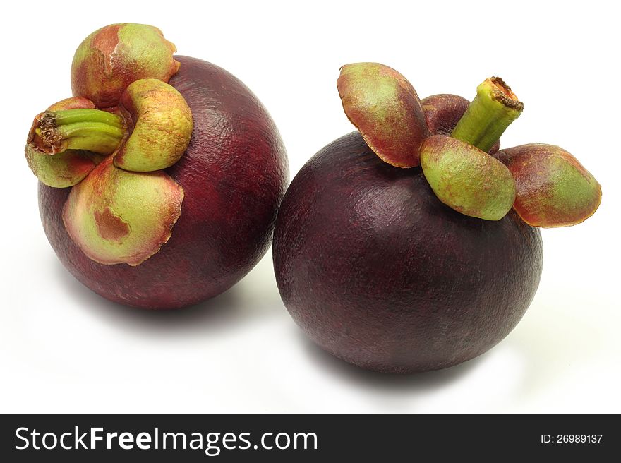 Two of fresh and juicy mangosteen isolated on white background