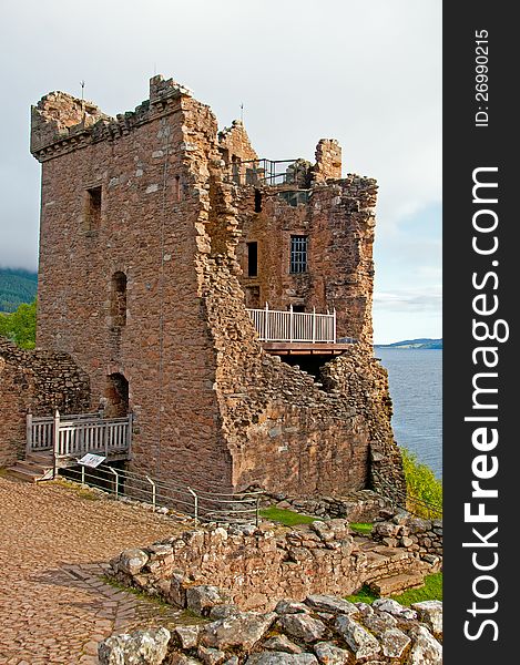 Grant hall, Urquhart castle, Loch Ness, Highlands, Scotland, U.K on the A82 Situated in one of Scotlandâ€™s most dramatic locations, the ruins of Urquhart Castle reflect the castleâ€™s turbulent past. A lively visitor centre sheds further light on everyday life at the castle. Historical background According to records, St Columba visited Loch Ness around 580. He travelled through Glen Urquhart, pausing to banish a marauding â€™water beastâ€™ and to baptise a Pictish nobleman as he lay dying in his fort. Although there is no concrete evidence to link this fort with the site at Urquhart, archaeological remains confirm that the highest part of the castle was a well-fortified site at this time. The castle surfaces from obscurity more than five hundred years later, around 1230, when Alexander II granted the Urquhart estate to Sir Thomas le Durward. His son, Alan, constructed the first castle on the south of the promontory at Urquhart. Holding a key strategic position in the glen, the castle suffered during the Wars of Independence. Captured by Edward I of England in 1296, it was surrendered to the Scots in 1298. The castle soon changed hands again when in 1308 Robert the Bruce took control of Urquhart for the Scottish Crown. From the end of the 14th century, the focus of conflict shifted to the west. The new enemies were the MacDonald clan, the Lords of the Isles. In 1395 the MacDonalds seized the lands and castle of Urquhart and for the next hundred years, the castle and glen. Grant hall, Urquhart castle, Loch Ness, Highlands, Scotland, U.K on the A82 Situated in one of Scotlandâ€™s most dramatic locations, the ruins of Urquhart Castle reflect the castleâ€™s turbulent past. A lively visitor centre sheds further light on everyday life at the castle. Historical background According to records, St Columba visited Loch Ness around 580. He travelled through Glen Urquhart, pausing to banish a marauding â€™water beastâ€™ and to baptise a Pictish nobleman as he lay dying in his fort. Although there is no concrete evidence to link this fort with the site at Urquhart, archaeological remains confirm that the highest part of the castle was a well-fortified site at this time. The castle surfaces from obscurity more than five hundred years later, around 1230, when Alexander II granted the Urquhart estate to Sir Thomas le Durward. His son, Alan, constructed the first castle on the south of the promontory at Urquhart. Holding a key strategic position in the glen, the castle suffered during the Wars of Independence. Captured by Edward I of England in 1296, it was surrendered to the Scots in 1298. The castle soon changed hands again when in 1308 Robert the Bruce took control of Urquhart for the Scottish Crown. From the end of the 14th century, the focus of conflict shifted to the west. The new enemies were the MacDonald clan, the Lords of the Isles. In 1395 the MacDonalds seized the lands and castle of Urquhart and for the next hundred years, the castle and glen