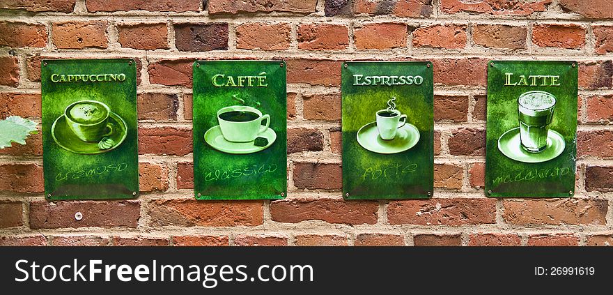 Old Coffee teasers on a brick wall