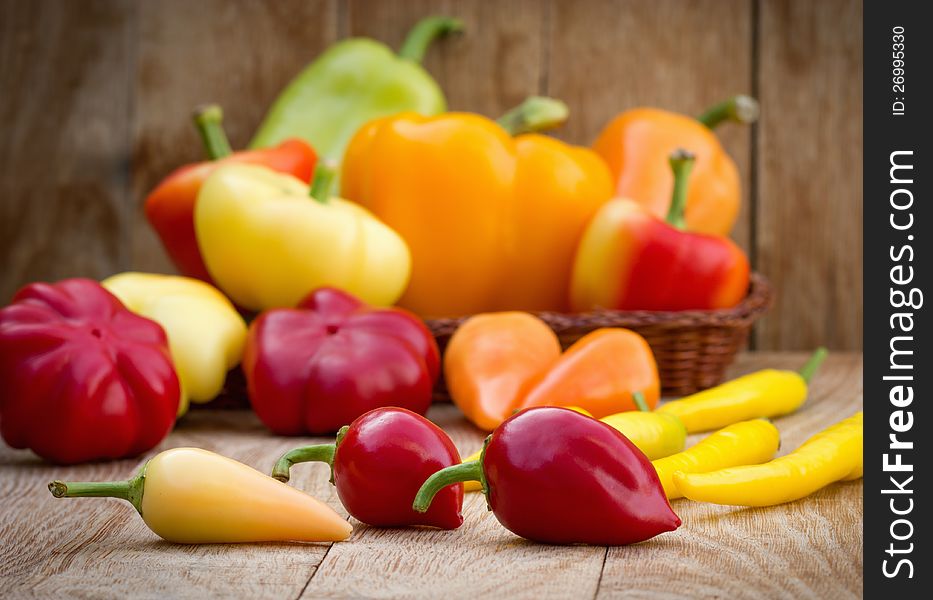 Colorful peppers on the wooden background