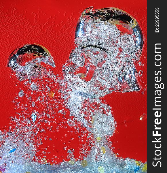 Airbubbles riising quickly and shattering in water in front of red background. Airbubbles riising quickly and shattering in water in front of red background