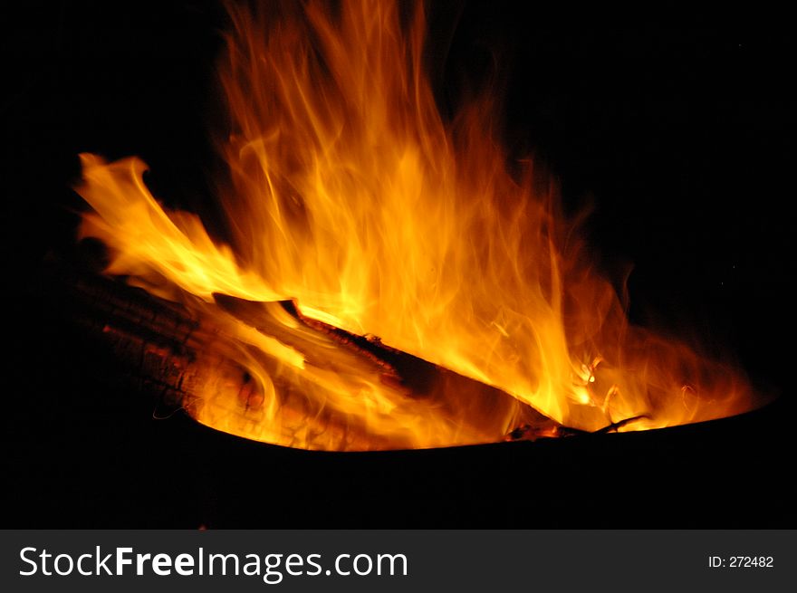 Closeup of campfire burning at night.