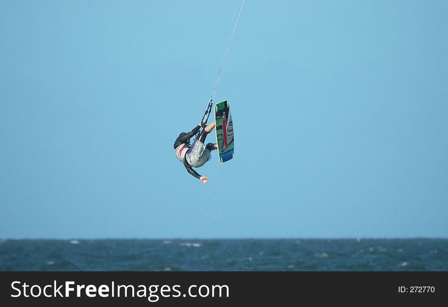 Kite surfer performing stunt. Kite surfer performing stunt