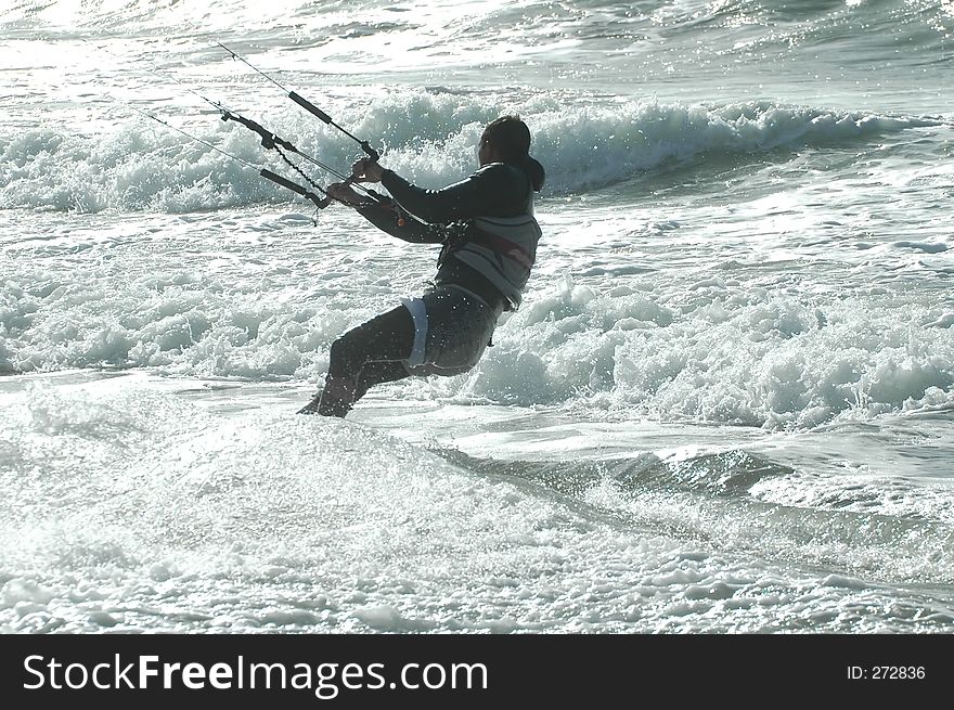 Surfer hanging onto kite. Surfer hanging onto kite