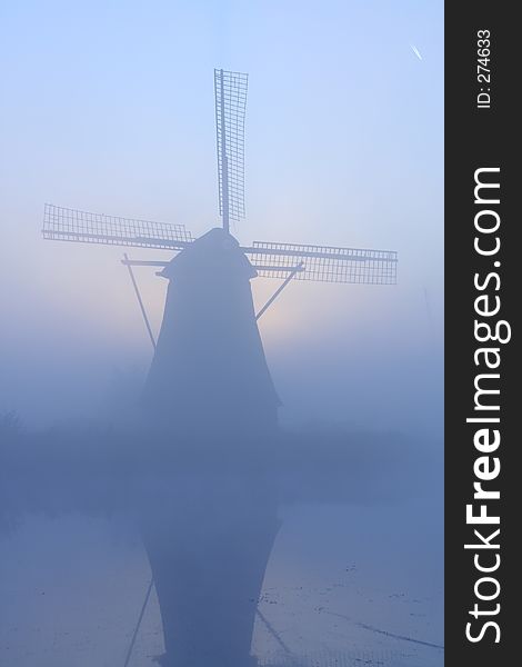 Windmill At A Misty Morning