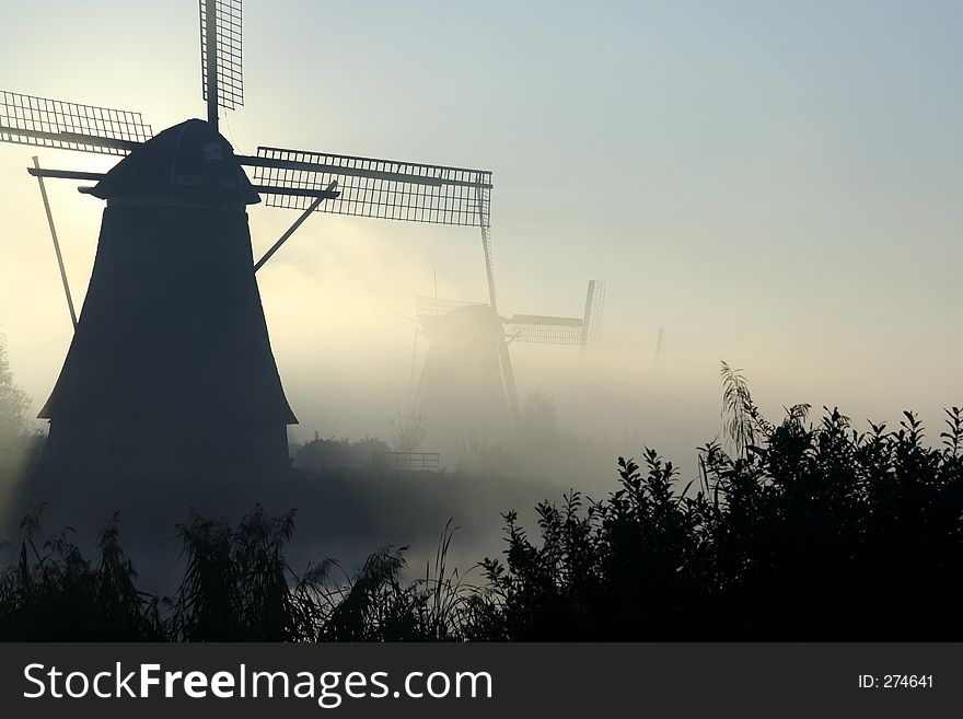 Windmills at a misty morning. Windmills at a misty morning