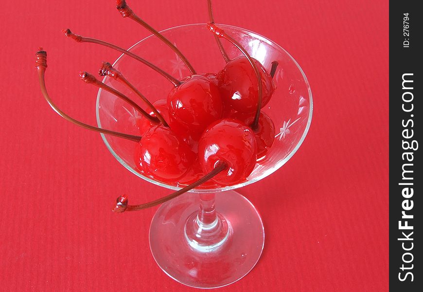 Red maraschino cherries in a martini glass. Red maraschino cherries in a martini glass.