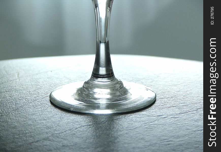 Wine glass stem, on black leather tray.