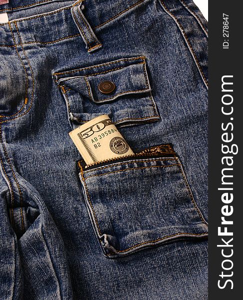 Pair of jeans with a fifty dollar bill sticking out of a pocket. Pair of jeans with a fifty dollar bill sticking out of a pocket
