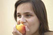 Girl Eating Big Peach Royalty Free Stock Photos