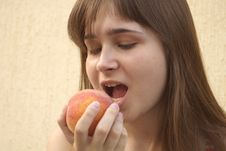Girl Eating Big Peach Stock Photo